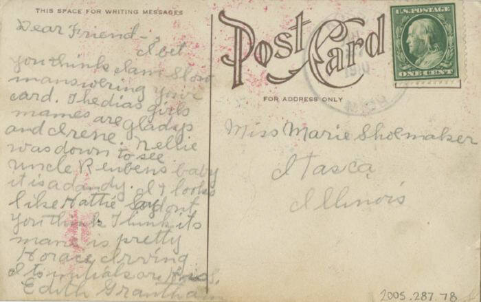 Back of a postcard with a handwritten message and green stamp.